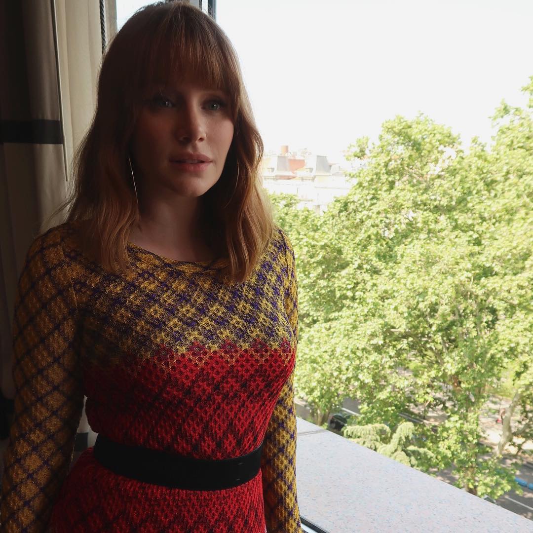 Mommy Bryce in a form-fitting crochet-knit dress, standing by the window and looking at you whistfully.